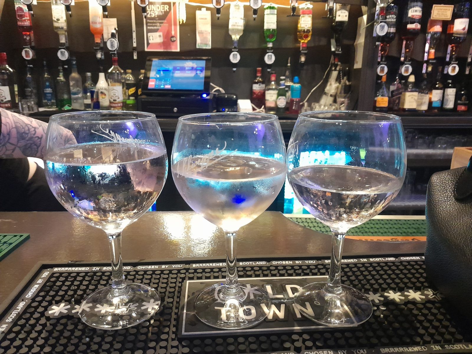 Gin serves at the bar, the Station Bar Alloa